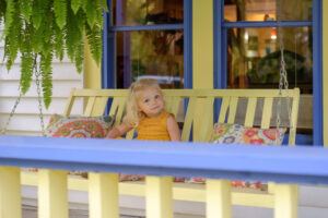 young girl enjoying porch swing