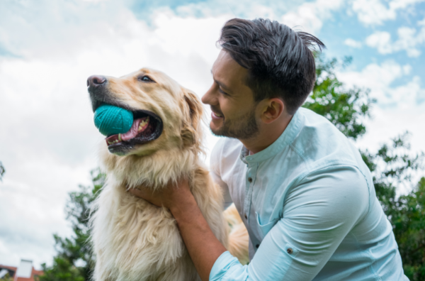 Man and dog playing in the backyard