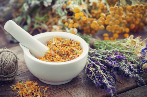Mortar and pestle with dried Marigold flowers